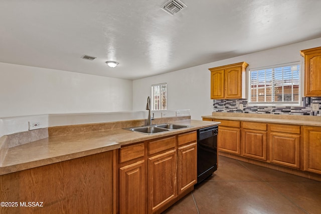 kitchen with dishwasher, backsplash, dark tile patterned floors, and sink