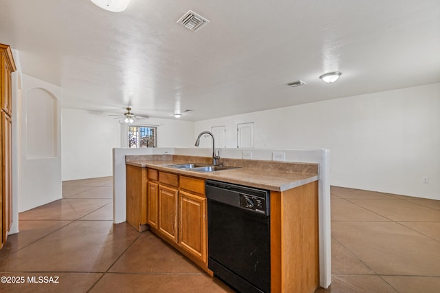 kitchen featuring ceiling fan, dishwasher, sink, a kitchen island with sink, and light tile patterned floors