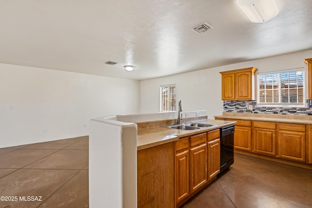 kitchen with backsplash, dishwasher, sink, and dark tile patterned flooring