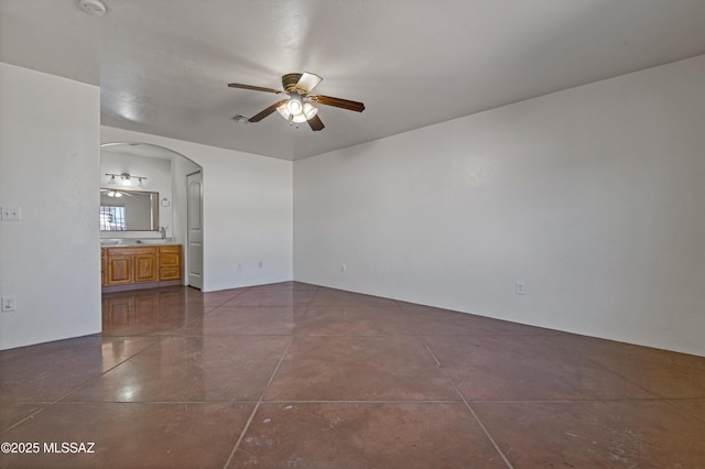 tiled spare room with ceiling fan