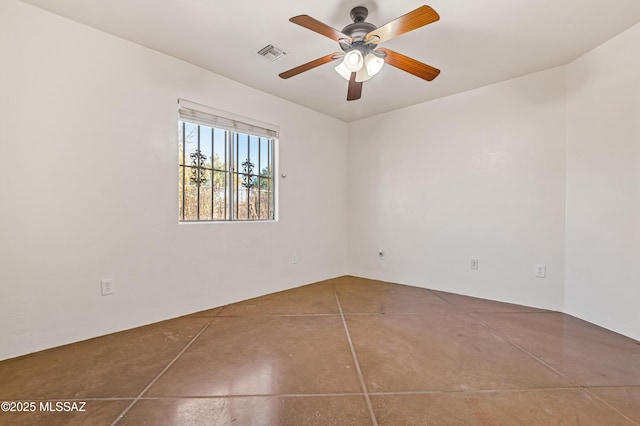 empty room with tile patterned floors and ceiling fan