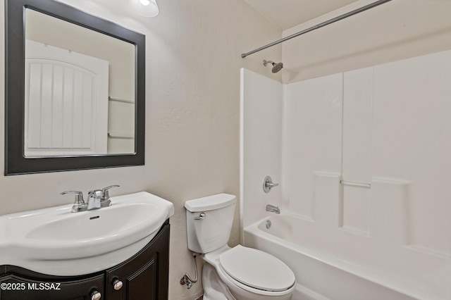 full bathroom with toilet, vanity, and washtub / shower combination