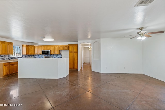 kitchen with tasteful backsplash and ceiling fan