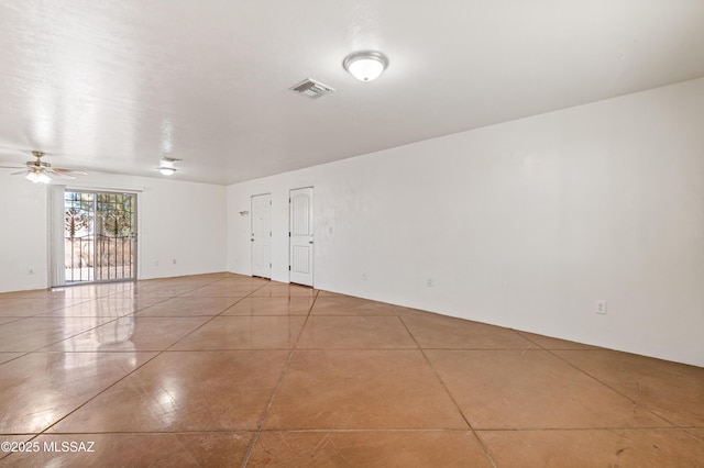 empty room featuring ceiling fan and light tile patterned floors