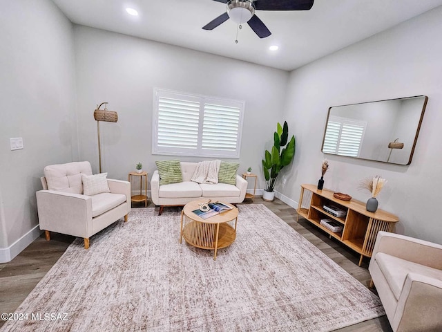 living room featuring dark hardwood / wood-style flooring and ceiling fan