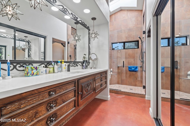 bathroom featuring a shower with door, concrete flooring, lofted ceiling with skylight, and vanity