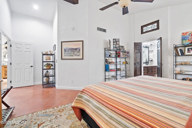 bedroom featuring a towering ceiling, ceiling fan, and connected bathroom