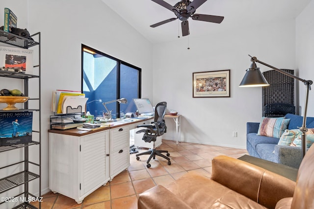 office area with vaulted ceiling, ceiling fan, and light tile patterned floors