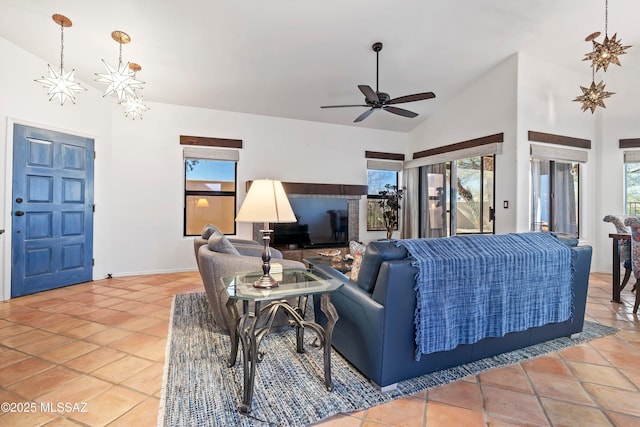 living room featuring lofted ceiling, tile patterned flooring, and ceiling fan