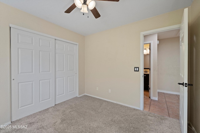 unfurnished bedroom with ceiling fan, light colored carpet, and a closet