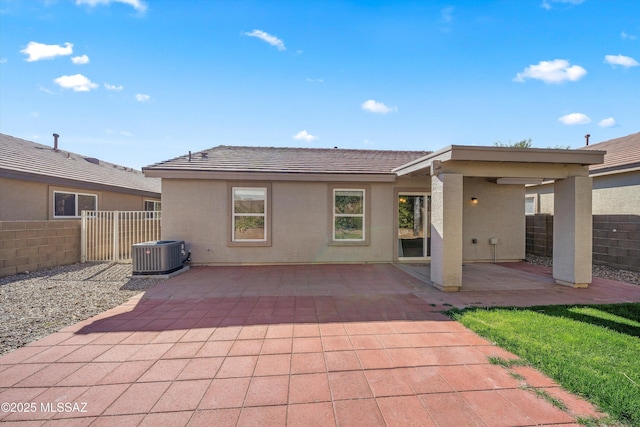 rear view of property with a patio area and central AC unit