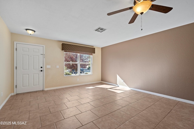 empty room featuring ceiling fan and light tile patterned floors