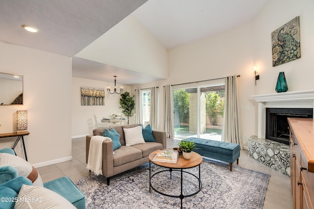 living room featuring light tile patterned floors, lofted ceiling, and an inviting chandelier