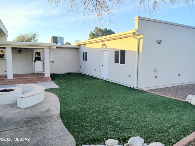 exterior space with a fire pit, a patio, and central air condition unit