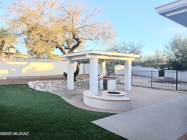 exterior space with a fire pit, a gazebo, a patio, and a fenced backyard