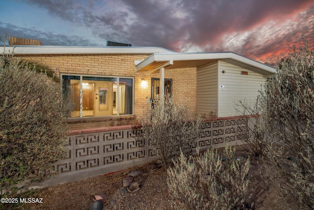 exterior space with brick siding