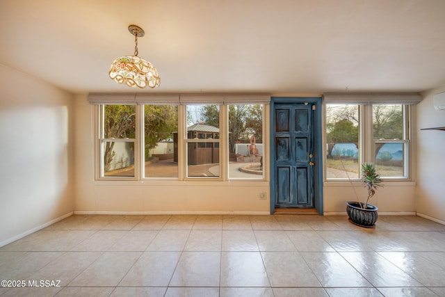 foyer entrance featuring tile patterned floors and baseboards