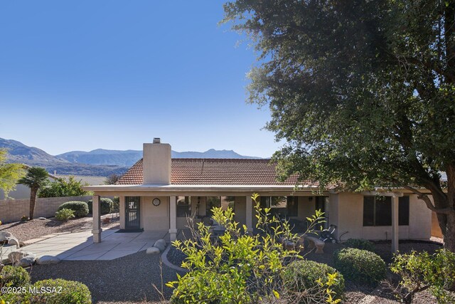 view of front facade with a patio area and a mountain view