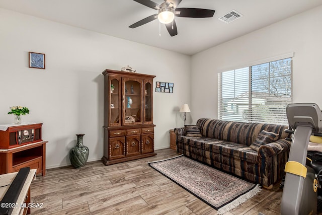 living room with ceiling fan and light hardwood / wood-style floors