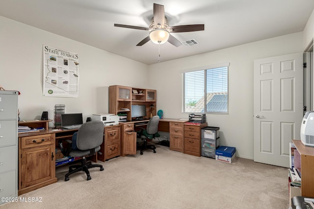 carpeted home office with ceiling fan