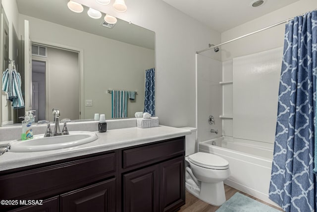 full bathroom with vanity, hardwood / wood-style flooring, toilet, and shower / bath combo with shower curtain