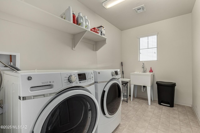 clothes washing area featuring washer and clothes dryer