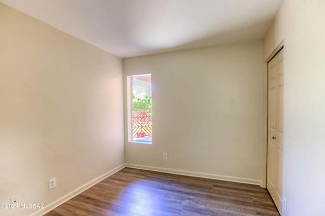 spare room with dark wood-type flooring