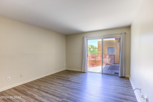 empty room with dark hardwood / wood-style floors