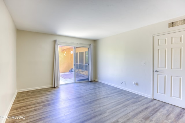 spare room featuring hardwood / wood-style floors