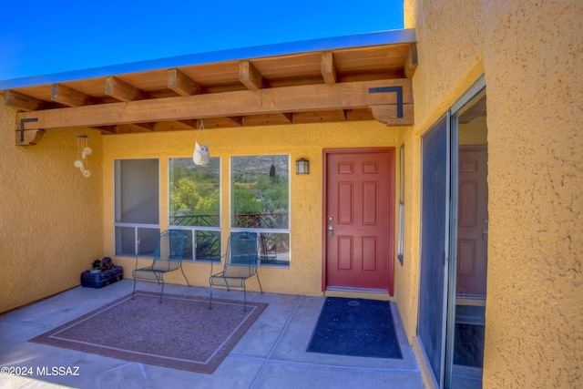 entrance to property featuring a patio area