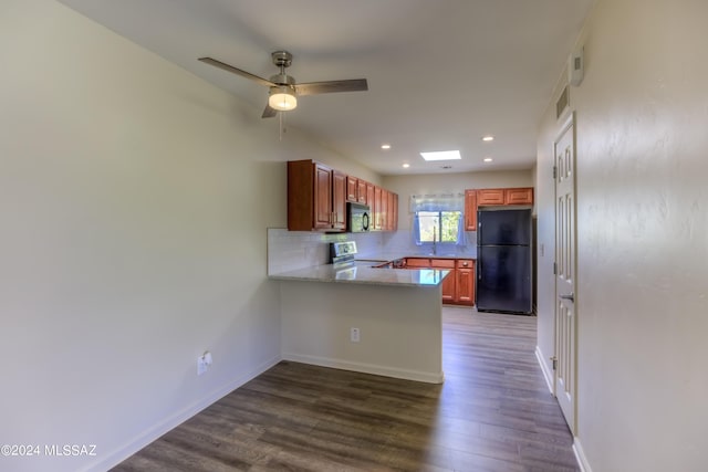 kitchen with kitchen peninsula, black appliances, tasteful backsplash, ceiling fan, and wood-type flooring