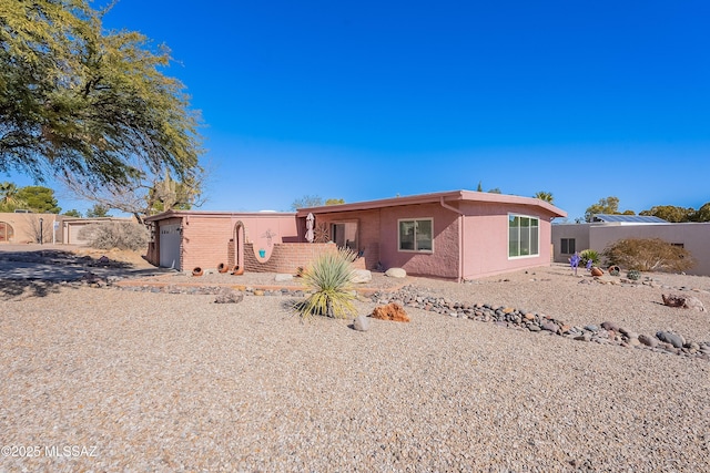 rear view of property with a garage