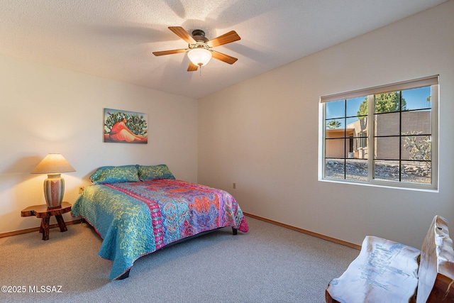 bedroom with ceiling fan, a textured ceiling, and carpet floors