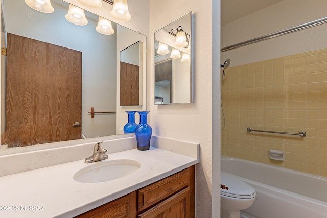 full bathroom with toilet, tiled shower / bath, and vanity