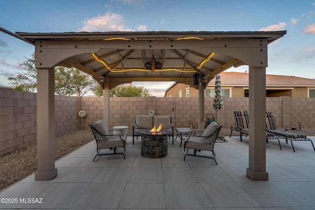 view of patio / terrace with an outdoor fire pit and a gazebo