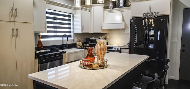 kitchen with white cabinetry, a kitchen island, custom range hood, and appliances with stainless steel finishes