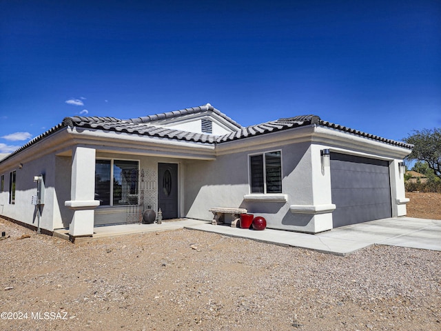 view of front of house with a porch and a garage