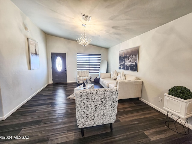 living room with vaulted ceiling, dark wood-type flooring, and a notable chandelier