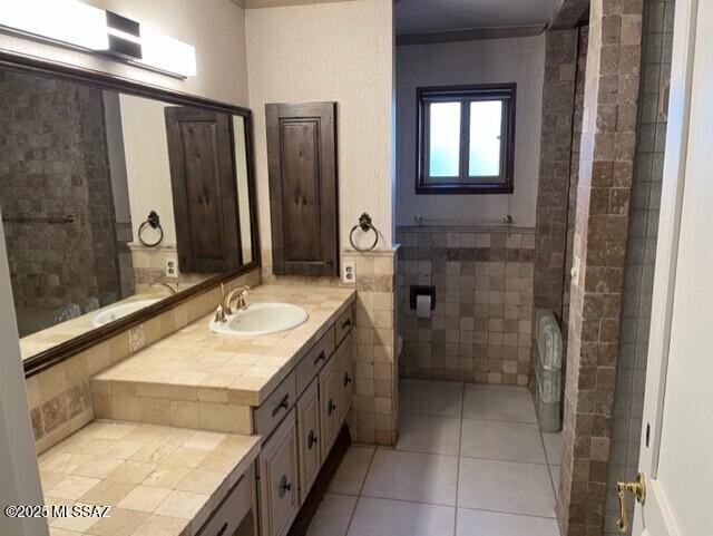 bathroom featuring vanity, tile walls, and tile patterned floors