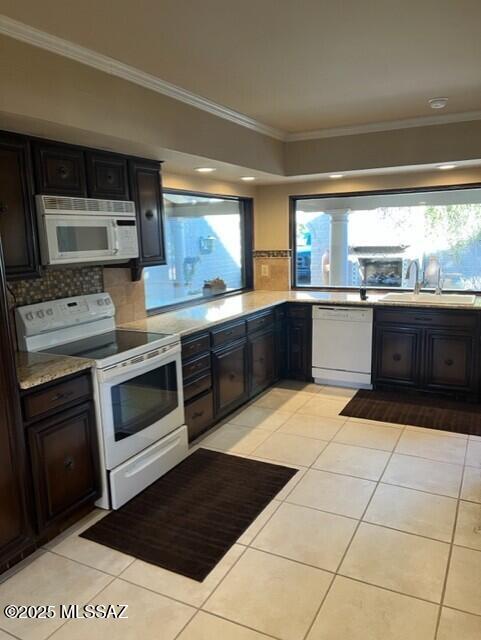 kitchen featuring tasteful backsplash, sink, white appliances, light tile patterned flooring, and ornamental molding