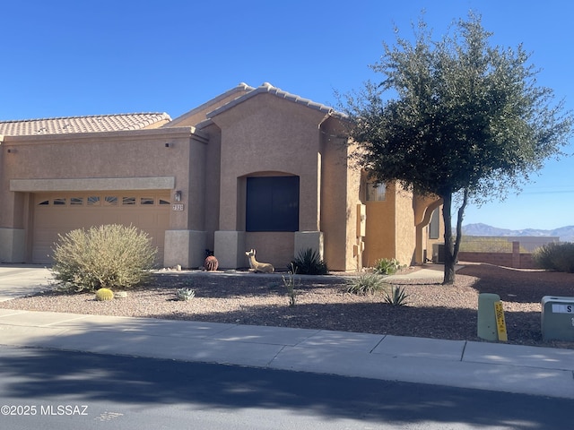 view of front of house with a mountain view and a garage