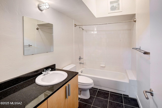 full bathroom with vanity, tiled shower / bath combo, tile patterned floors, and toilet