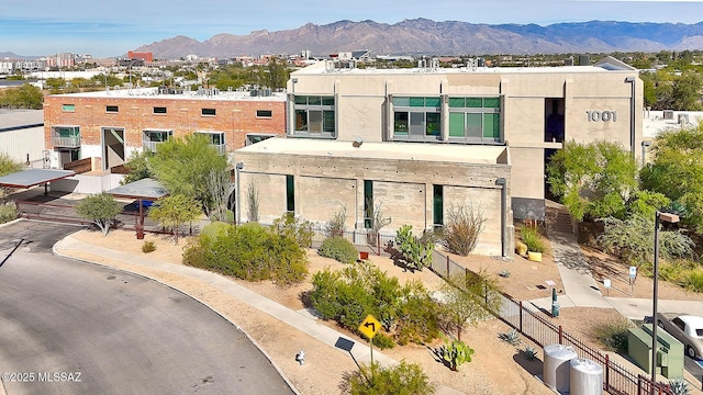 view of building exterior with cooling unit and a mountain view