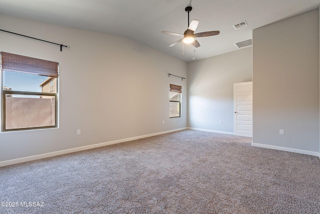 carpeted empty room with ceiling fan and vaulted ceiling