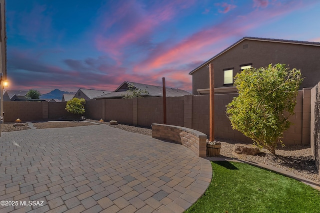 view of patio terrace at dusk