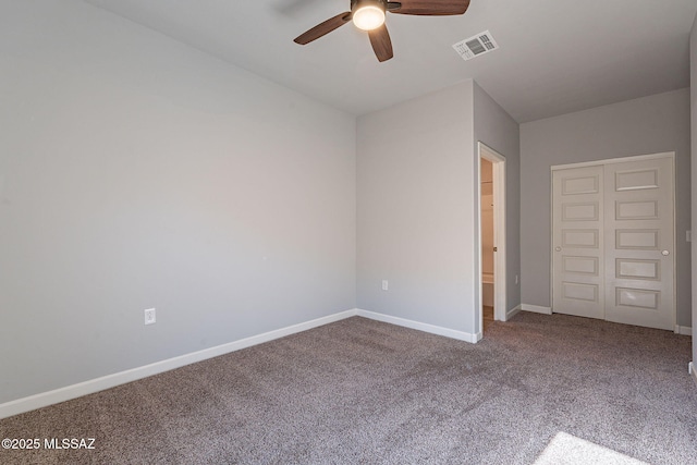 unfurnished bedroom with ceiling fan, a closet, and carpet