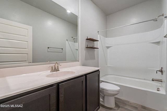 full bathroom with toilet, vanity, shower / tub combination, and hardwood / wood-style floors