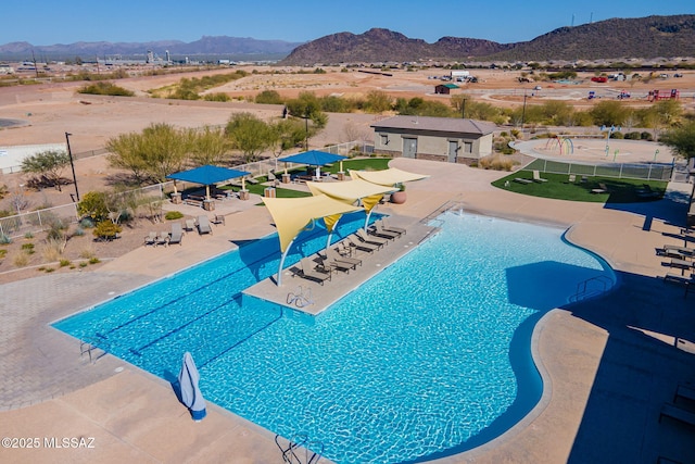 view of pool featuring a patio and a mountain view