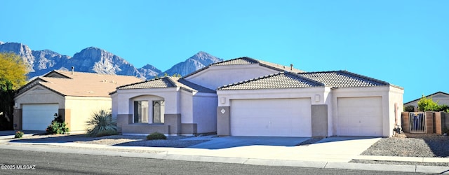 view of front of property featuring a mountain view and a garage