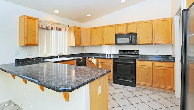 kitchen with kitchen peninsula, light tile patterned floors, black appliances, and lofted ceiling